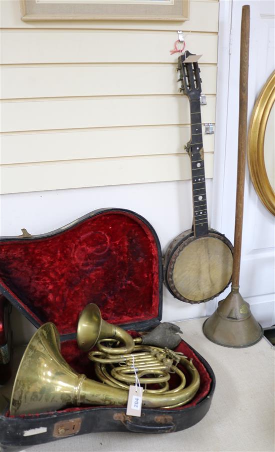 A cased horn, a French horn, a banjo etc (4)